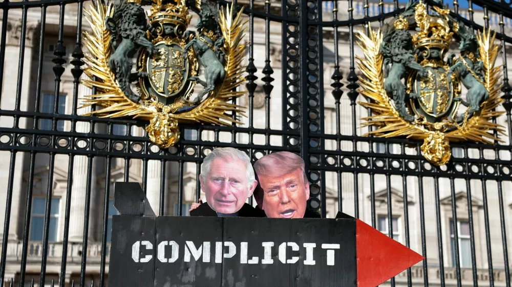 People from The Stop Trump Coalition dressed as Britain's King Charles and U.S. President Donald Trump hold a prop missile outside Buckingham Palace as the group opposes the bombing of Iran and calls on the UK to stop allowing use of UK military bases by U.S. aircraft, in London, Britain, April 27, 2026. REUTERS/Hannah McKay