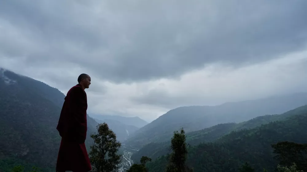 A monk walks by the Jigaon monastery in Sherdukpen village in West Kameng, Arunachal Pradeshin, India, Sunday, April 26, 2026. (AP Photo/Anupam Nath)