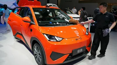 A staff member dusts a BYD Seagull electric vehicle (EV) displayed at the Beijing International Automotive Exhibition, or Auto China, in Beijing, China April 26, 2026. REUTERS/Xiaoyu Yin