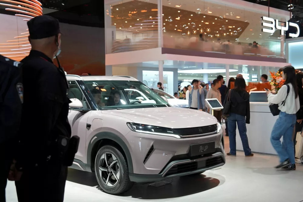 Visitors check a BYD Yuan UP electric vehicle (EV) displayed at the Beijing International Automotive Exhibition, or Auto China, in Beijing, China April 26, 2026. REUTERS/Xiaoyu Yin