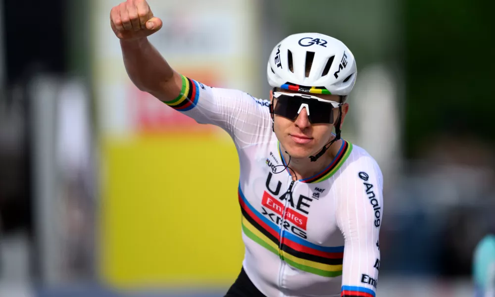 Tadej Pogacar from Slovenia raises his arms after crossing the finish line to win the first stage, a 170,6 km race around Martigny, at the 79th Tour de Romandie cycling race, in Saint-Maurice, Switzerland, Wednesday, April 29, 2026. (Laurent Gillieron/Keystone via AP)