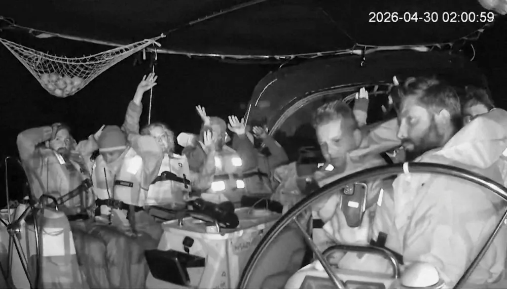 Attention Editors: This image has been cropped by Reuters to enhance quality, and an uncropped version has been provided separately. CCTV footage shows crew members of the second flotilla that sailed from the Spanish port of Barcelona, carrying humanitarian aid to Palestinians in Gaza, raise their arms as the vessel is said to be intercepted by the Israeli Army, at a location given as at sea off the coast of Greece, April 30, 2026, in this screengrab taken from a handout video. Global Sumud Flotilla/Handout via REUTERS  THIS IMAGE HAS BEEN SUPPLIED BY A THIRD PARTY. NO RESALES. NO ARCHIVES. MANDATORY CREDIT. TIME STAMP FROM SOURCE.  VERIFICATION - Location not verified but Global Sumud Flotilla's vessel tracker website shows vessels were intercepted at sea offcoast Greece Date confirmed from the timestamp of the CCTV footage Israel has begun taking control of aid ships bound for Gaza far from Israeli shores, Israeli army radio cited an Israeli source as saying on Wednesday Global Sumud Flotilla confirmed in a statement that their vessels were intercepted by Israeli forces on Wednesday