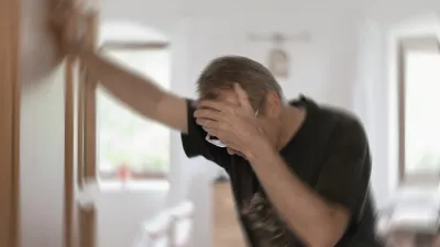 Man suffering from vertigo or dizziness or other health problem of brain or inner ear.