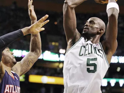 Boston Celtics power forward Kevin Garnett (5) shoots over Atlanta Hawks power forward Josh Smith (5) during the first half of Game 6 in a first-round NBA basketball playoff series in Boston, Thursday, May 10, 2012. The Celtics won 83-80 and won the series 4-2 to advance to the second round. (AP Photo/Charles Krupa)