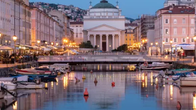 View of the Ponte Rosso bridge and the Church of St. Anthony the Thaumaturge reflected in the canal in the heart of Trieste, Italy.