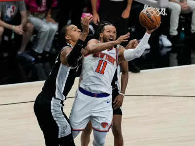 New York Knicks guard Jalen Brunson (11) drives past San Antonio Spurs forward Victor Wembanyama, left, during the first half of Game 1 of the NBA Finals basketball series, Wednesday, June 3, 2026, in San Antonio. (AP Photo/David J. Phillip)