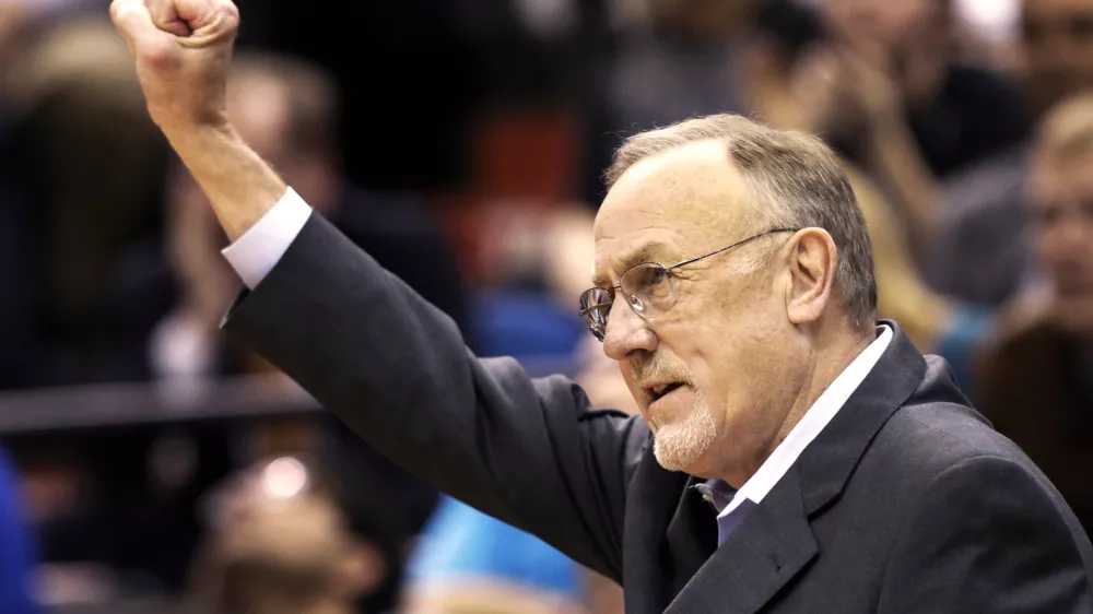 FILE - Minnesota Timberwolves head coach Rick Adelman celebrates a defensive rebound by Ricky Rubio in the second half of an NBA basketball game against Oklahoma City Thunder, March 29, 2013,in Minneapolis. (AP Photo/Jim Mone, File)