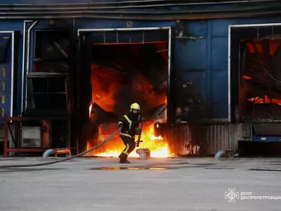 In this photo provided by the Ukrainian Emergency Services on Thursday, June 4, 2026, a rescue worker puts out a fire of a storage depot damaged after a Russian strike on Dnipropetrovsk region, Ukraine. (Ukrainian Emergency Service via AP)