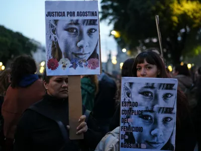 Demonstrators hold photos of 14-year-old Agostina Vega, who was murdered, during a march marking the anniversary of the "Ni Una Menos" (Not One Fewer) women's movement in Buenos Aires, Argentina, Wednesday, June 3, 2026. (AP Photo/Natacha Pisarenko)