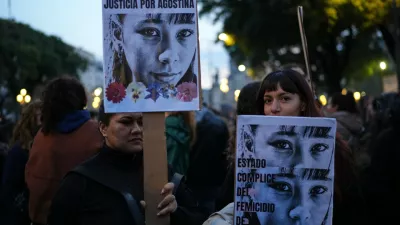 Demonstrators hold photos of 14-year-old Agostina Vega, who was murdered, during a march marking the anniversary of the "Ni Una Menos" (Not One Fewer) women's movement in Buenos Aires, Argentina, Wednesday, June 3, 2026. (AP Photo/Natacha Pisarenko)