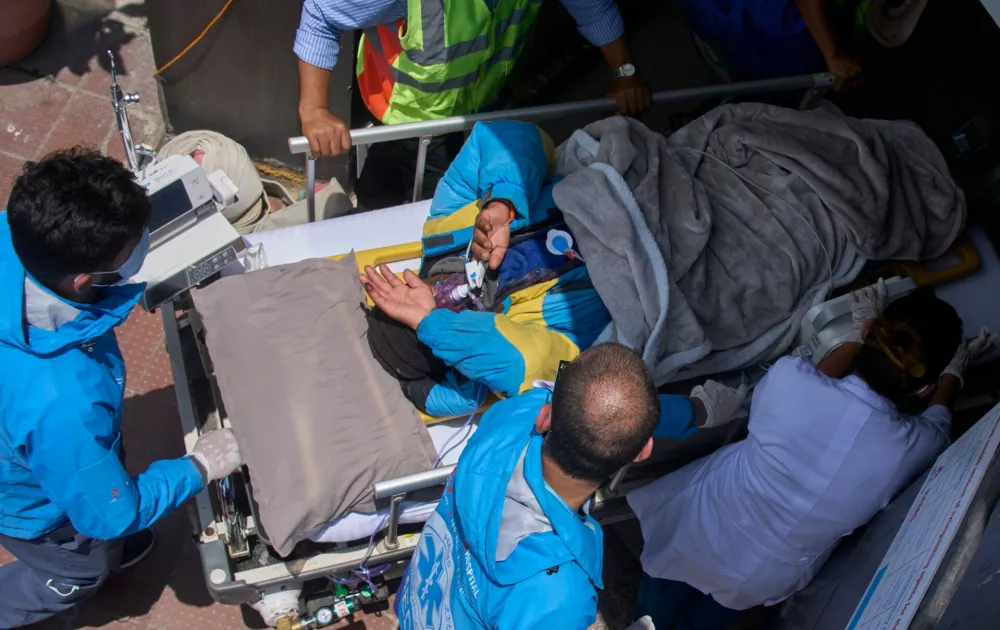 Medics take Dawa Sherpa, a mountain guide who had been missing for several days in the Everest region, for treatment after he arrived at HAMS Hospital in Kathmandu, Nepal, Thursday, June 4, 2026. (AP Photo/Niranjan Shrestha) CORRECTION: Corrects hospital name to HAMS not Grande
