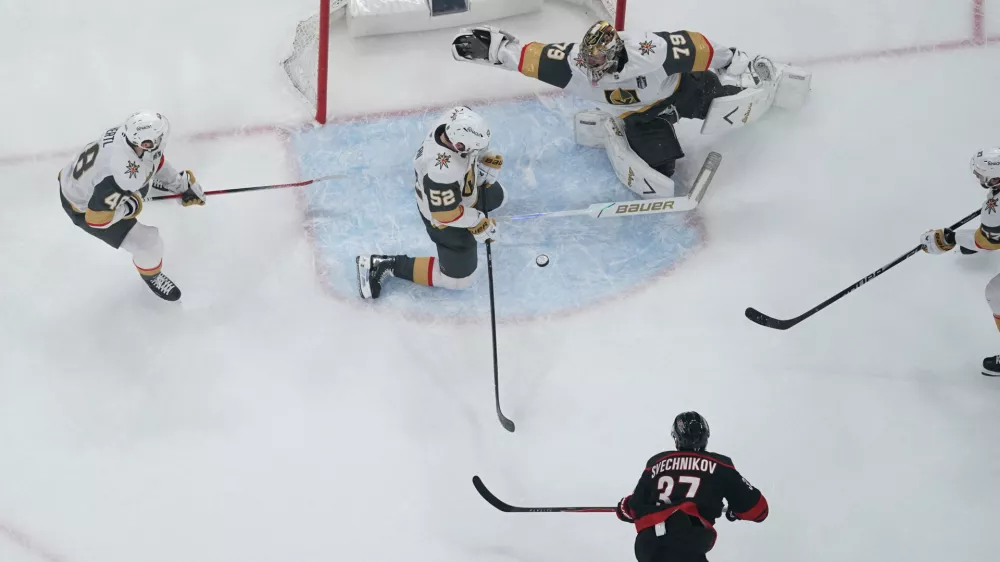 Jun 4, 2026; Raleigh, North Carolina, USA; Vegas Golden Knights goaltender Carter Hart (79) and defenseman Dylan Coghlan (52) defend against Carolina Hurricanes right wing Andrei Svechnikov (37) during the first period in game two of the 2026 Stanley Cup Final at Lenovo Center. Mandatory Credit: James Guillory-Imagn Images