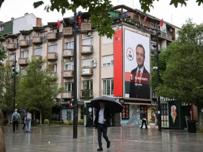 People walk near an election poster showing Prime Minister of Kosovo and Levizja Vetevendosje (Movement for Self-Determination) party leader Albin Kurti, in Pristina, Kosovo, June 4, 2026. Kosovo is to hold a snap parliamentary election, the third in just over a year, after parliament failed to elect a new head of state. REUTERS/Valdrin Xhemaj