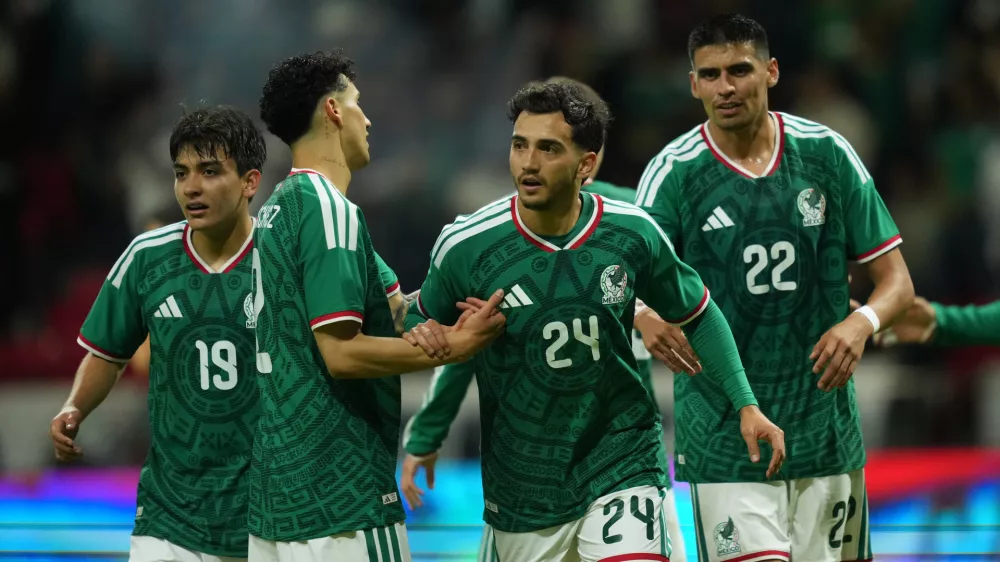 Mexico's Luis Chavez, is congratulated after scoring his side's 5th goal against Serbia during an international friendly soccer match in Toluca, Mexico, Thursday, June 4, 2026. (AP Photo/Moises Castillo)