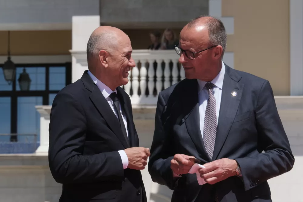Slovenia's Prime Minister Janez Jansa, left, speaks with German Chancellor Friedrich Merz during the EU-Western Balkans summit in the Montenegrin coastal town of Tivat, Friday, June 5, 2026. (AP Photo/Risto Bozovic)