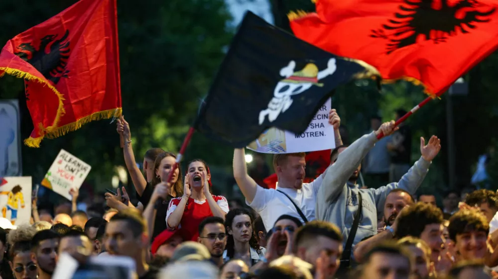 Protesters wave Albanian national flags during a protest against a luxury resort development planned by a company linked with Donald Trump's son-in-law, Jared Kushner, on an environmentally sensitive part of the Adriatic coast, in Tirana, Albania, June 4, 2026. REUTERS/Florion Goga