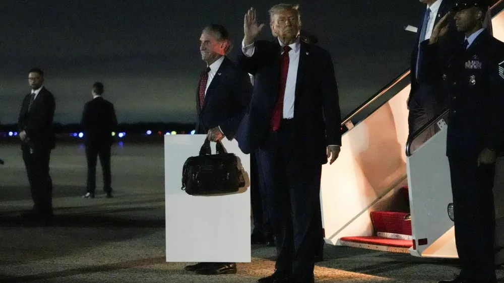 U.S. President Donald Trump waves as he disembarks from Air Force One, after attending Game 3 of the NBA Finals, at Joint Base Andrews, Maryland, U.S., June 9, 2026. REUTERS/Nathan Howard