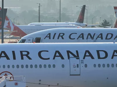 FILE - Air Canada planes sit on the runway at Pearson International Airport in Toronto on Aug. 16, 2025. (Sammy Kogan/The Canadian Press via AP, File)