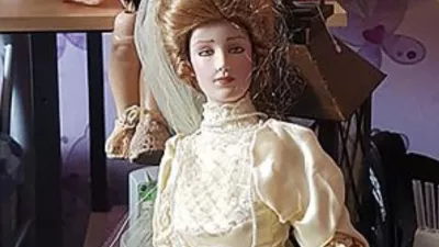 Story from Jam Press (Most Haunted Doll)Pictured: Elizabeth the doll.'I own Britain's most haunted doll &ndash; people flee the room in tears when she scratches them and pulls their hair'Visitors claim they were scratched and had their hair pulled after gathering to see a doll dubbed Britain's "most haunted".Elizabeth, a porcelain bridal doll, has already built a notorious reputation online after years of alleged paranormal incidents.But now the doll's owner, Lee Steer, says a new wave of strange encounters during two public open days has left even sceptics unsettled.The 40-year-old, who owns the Haunted Objects Museum in Rotherham, South Yorks, where the doll is kept, claims dozens of people in recent months have reported unusual experiences."Quite a few people have refused to be in the same room as Elizabeth during public museum events, especially at night," Lee, from Rotherham, South Yorks, told creatorzine.com."Some visitors feel uncomfortable almost immediately and choose to leave rather than stay near her."The incidents were spread across both days, but there did seem to be a period where activity became noticeably more concentrated, around 2pm seemed to be when the most reports started coming in."On the first day, there were cold drafts, temperature changes being picked up on the paranormal equipment, movement involving a pram, and two separate visitors claiming their hair had been pulled."On the second day, the bell-trigger equipment appeared much more active and responsive."We also had a visitor report their hair bobble being tugged, and another person noticed their bag had opened unexpectedly while near the doll."There were visitors who became overwhelmed enough to leave the room, and in some cases even step outside the building entirely to calm themselves down before returning."Once other guests started sharing their own experiences, the atmosphere naturally became much more intense, and for some people that clearly heightened the fear factor."Elizabeth, believed to be a Franklin Mint Gibson Girl bridal collector doll dating from the late 1980s, first hit headlines years ago after previous owner Debbie Merrick claimed disturbing incidents began happening in her home.According to Lee, the doll had originally been discovered in a skip before ending up in an antiques shop, where Debbie later bought it.She allegedly experienced unexplained fire alarms, moved objects and mysterious scratches before eventually listing the doll on eBay simply as a "creepy doll".Lee purchased Elizabeth for Ł866 after stumbling across the auction.He said: "For reasons I still can't fully explain, I felt drawn to the doll and decided to bid, without fully realising I was bidding on a doll that was already attracting serious press interest."Over the years, more than 30 individuals have claimed unusual experiences after being around the doll, including unexplained scratches, burns, emotional distress, strange dreams, and other unsettling incidents."Since then, Elizabeth has become one of Britain's best-known allegedly haunted objects.But Lee says the most recent incidents have been among the strangest yet.During special daytime opening events at the museum, visitors travelled from across the UK specifically to spend time near the doll.Several people reported phones freezing, restarting or refusing to record near the doll.Lee said: "Since I bought Elizabeth, lights flicker, objects move, items are knocked over, and strange disturbances happening when there's no obvious explanation."What's always stood out to me is that it often seems to happen when something new is introduced into the museum, almost like a jealous reaction."Whether that's paranormal or something else, those moments are definitely the creepiest to witness firsthand."One particularly unsettling moment involved a child's pram which visitors claimed appeared to move on its own.Another example, he claims, involved perfume bottles being "thrown across a room with force" rather than simply falling over accidentally.According to Lee, a man who had spent time around Elizabeth later collapsed during a Ouija board session in another part of the building.Lee insists he remains sceptical despite years spent investigating the doll.He said: "I think scepticism is healthy."In some cases there may well be logical explanations such as accidental scratches, environmental factors, or people simply not noticing when something happened."What makes it interesting to me is when similar reports keep coming from different people, often independently of each other."I'm not here to force a paranormal explanation on anyone, but after seeing the number of repeated claims over the years, I do think it's worth documenting and investigating rather than dismissing outright."I fully understand that in today's world, with social media, editing, and AI, people question everything and rightly so."But for me, what matters most is what I've personally seen and experienced in real life that I genuinely can't explain through normal means."Following the latest incidents, Lee says stricter rules may soon be introduced for guests entering Elizabeth's room, including requests not to provoke or mock the doll.Visitors are forbidden from touching Elizabeth.Despite the doll's sinister reputation, Lee says he has no plans to get rid of her, despite believing she could be dangerous.Lee said: "If ghosts or paranormal energy are genuinely real, then Elizabeth could potentially be dangerous simply because of the type of incidents people have associated with her over the years."It's not just scratches, it's the larger disturbances that make you think."There was even an incident at a London train station where the departure boards went down while travelling with her."That could absolutely be coincidence or bad timing, and I'm honest about that."But when you start seeing enough strange incidents stack up around one object, you naturally begin asking bigger questions."Whatever is happening around Elizabeth, whether paranormal or something else, I'm interested in understanding it rather than getting rid of her."ENDSEDITOR'S NOTE: Video Usage Licence: (EXCLUSIVE) We have obtained an exclusive licence from the copyright holder. A copy of the licence is available on request.Video Restrictions: None.,Image: 1106387403, License: Rights-managed, Restrictions: EDITOR'S NOTE: Video Usage Licence: (EXCLUSIVE) We have obtained an exclusive licence from the copyright holder. A copy of the licence is available on request.Video Restrictions: None., Model Release: no 