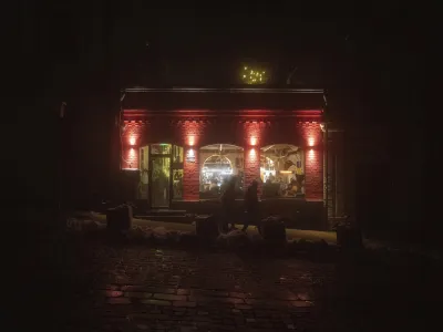 FILE - People walk past a cafe in the city center which lost electrical power after yesterday's Russian rocket attack in Kyiv, Ukraine, Nov. 24, 2022. The hard realities of Ukraine's capital are that a once comfortably livable city of 3 million people is now becoming a tough place to live. But Kyiv has hope, resilience and defiance in abundance. And perhaps more so now than at any time since Russia invaded Ukraine nine months ago. (AP Photo/Evgeniy Maloletka, File)