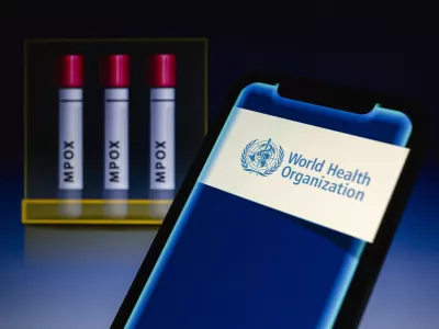 14 August 2024, Paraguay, Asunci&oacute;n: World Health Organization (WHO) logo is displayed on a smartphone in front of visual representation of test tubes labeled 'mpox'. WHO on 14 August 'has determined that the upsurge of mpox in the Democratic Republic of the Congo (DRC) and a growing number of countries in Africa constitutes a public health emergency of international concern (PHEIC) under the International Health Regulations (2005) (IHR).' Photo: Andre M. Chang/ZUMA Press Wire/dpa