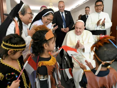 Pope Francis interacts with children as he meets with migrants, during his apostolic visit to Asia, in Jakarta, Indonesia September 3, 2024. Vatican Media/&shy;Handout via REUTERS  ATTENTION EDITORS - THIS IMAGE WAS PROVIDED BY A THIRD PARTY.